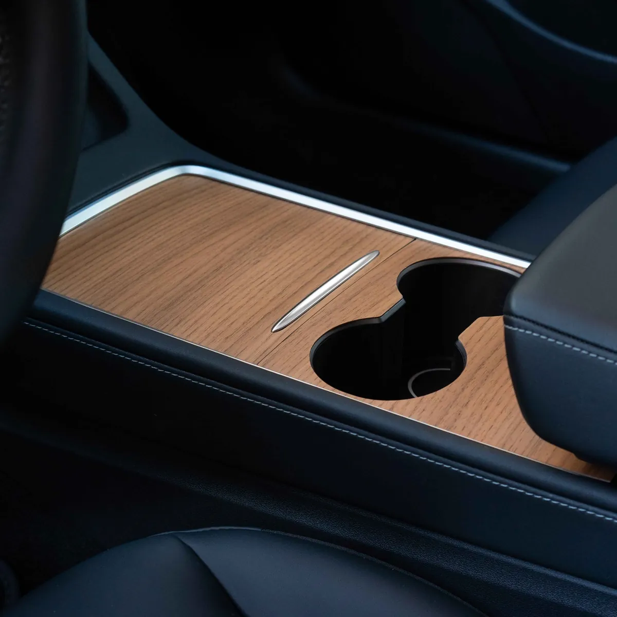 A finished Hills wood console cover installed in a Tesla