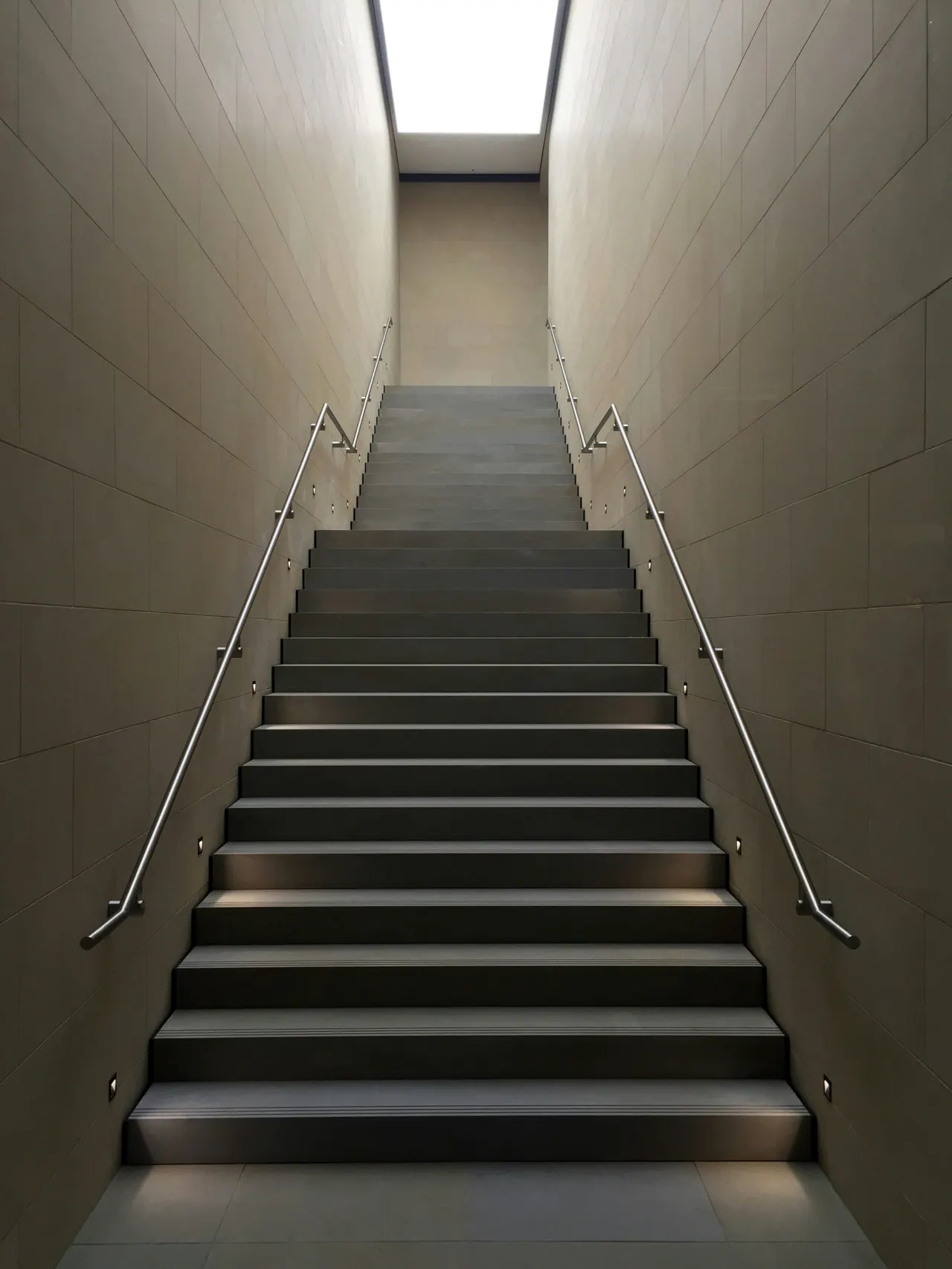 A symmetrical stairwell rising to a skylight
