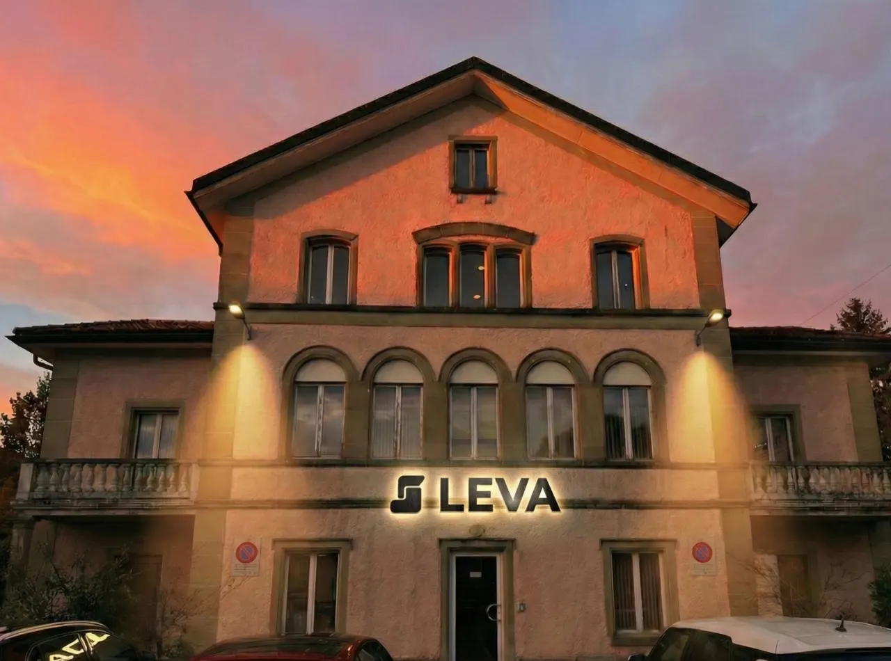 The Leva building in Corbières at dusk, its lettering lit