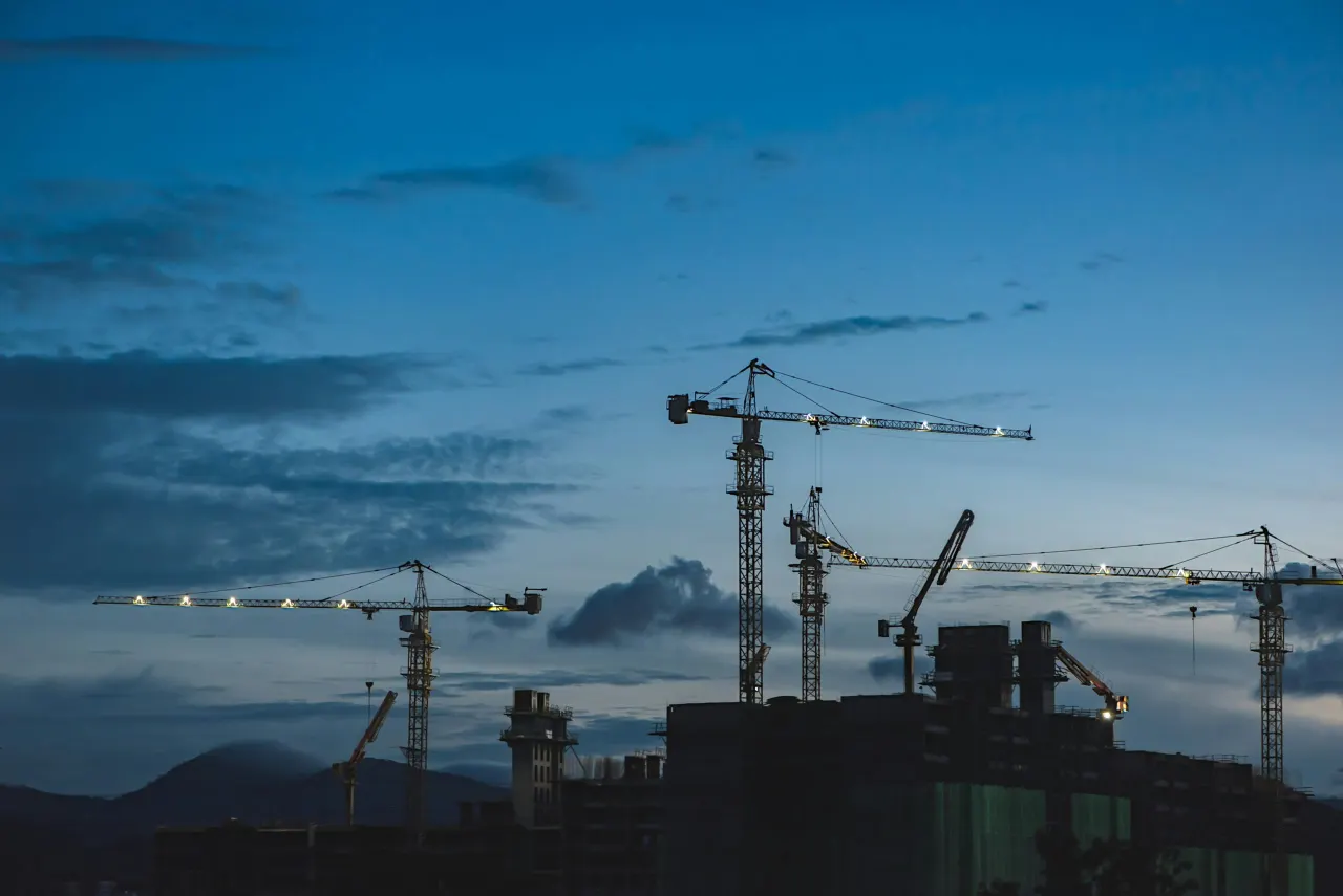 Construction cranes at the blue hour